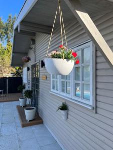 a flower pot hanging from the side of a house at Unique one bedroom guest house with free parking in Aldershot
