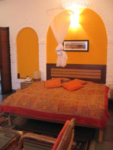 a bedroom with a bed with an umbrella on it at B Nineteen in New Delhi