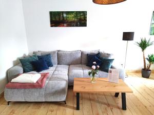 a living room with a couch and a coffee table at FeRo´s Ferienwohnung in Wernigerode +28 photos