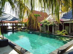a large swimming pool in the middle of a building at Talent Sunset Villa in Gili Islands