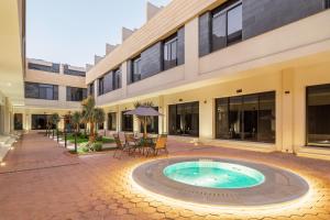 a courtyard with a pool in front of a building at Mabaat - Nala Al Rawdah - 604 in Jeddah