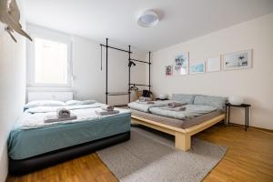 a bedroom with two beds and a couch at KAwaii- Big island in central location in Karlsruhe