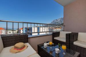 a balcony with a table with a hat on it at I and A Cozy MAKARSKA in Makarska