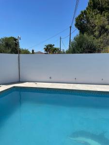 a swimming pool in front of a white fence at Casa Rural Los Caballos Finca Canca Alora Caminito del Rey in Alora