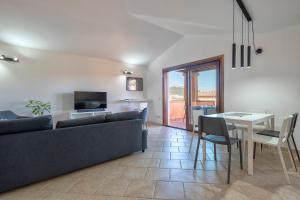 a living room with a couch and a table at House of Lens in Golfo Aranci