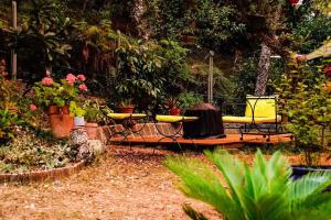 a garden with a table and chairs and flowers at YOG Studios Hossegor in Soorts-Hossegor