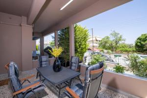 eine Terrasse mit Tisch und Stühlen auf einem Balkon in der Unterkunft Rena's luxury apartment with free private parking in Chania + 10 Fotos