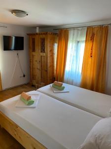 a bedroom with a large white bed with two towels at Casa Donau Delta in Sulina