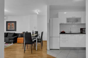 a kitchen and dining room with a table and chairs at I and A Cozy MAKARSKA in Makarska