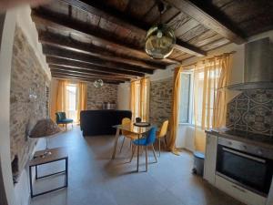 a living room with a table and a fireplace at Casa Pernice in Penta-di-Casinca