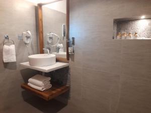 a bathroom with a sink and a shower at Oruwa Boutique Villas in Arugam Bay