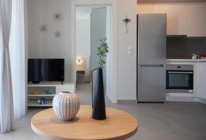 a kitchen with a table with a vase on it at LUMIERE VILLAS in Kanali