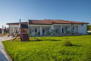 a house with a yard with a playground at Комплекс Радост in Ezerets