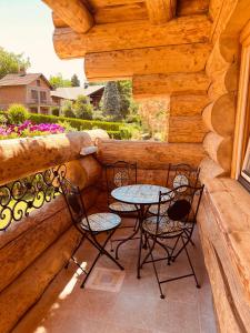 a patio with two chairs and a table on a porch at Brvnara Antika in Veliko Gradište