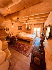 a bedroom with a bed in a log cabin at Brvnara Antika in Veliko Gradište
