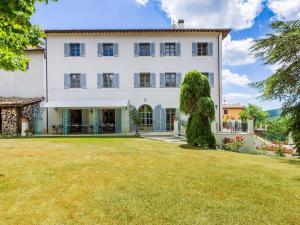 una vista esterna di una grande casa bianca con cortile di Cheerful holiday home in Serravalle di Chienti with garden a Serravalle di Chienti