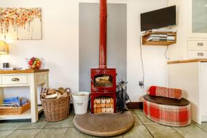 a living room with a wood stove in the corner at Willow Cottage in Ulrome