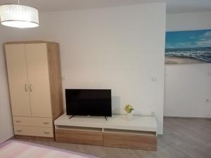 a living room with a tv on a white wall at Studio apartment Iva in Bale