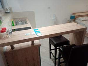 a kitchen with a wooden counter with a sink and stool at Studio apartment Iva in Bale +11 photos
