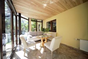 a living room with a table and chairs at The Paradise House in Riga