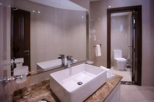 a bathroom with a white sink and a toilet at Villa Asiana - Exclusive 8-Bedroom Villa with signature Amenities By Luxury Explorers Collection in Dubai
