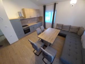 een woonkamer met een tafel en stoelen bij Apartments LAURA in Fažana