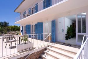 a balcony of a house with blue shutters at Pansion Jakas in Zavala