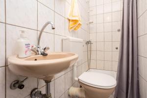 a bathroom with a sink and a toilet at Apartments Filosevic by El-Pi Tours in Njivice +39 photos