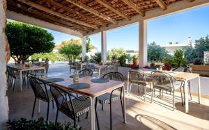 a restaurant with tables and chairs on a patio at Pansion Jakas in Zavala