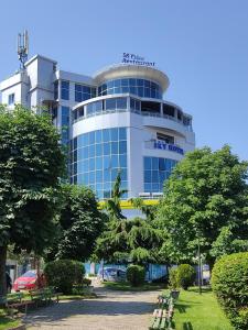 a large building with a sign on top of it at Sky View Hotel in Korçë