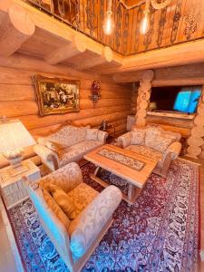 a living room with couches and a table at Brvnara Antika in Veliko Gradište