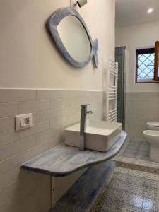 baño con lavabo y espejo en la pared en TERMOLI, NEL CUORE DEL CENTRO STORICO, en Termoli