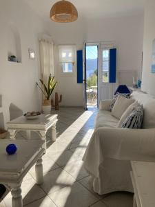 a living room with a couch and a table at Sea and Sun beach house at Platis Gialos in Platis Gialos