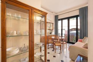 a living room with a dining table and a glass cabinet at 5 Mehari in Varigotti +19 photos