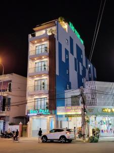 un edificio con un coche aparcado delante de él en HÀO PHÁT HOTEL NHA TRANG en Nha Trang