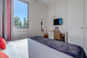 Postel nebo postele na pokoji v ubytování Hôtel Miléade Méditerranée - Port-Fréjus