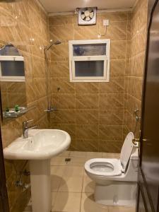 a bathroom with a toilet and a sink at Al Safiah Hotel in Al Madinah