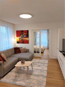 a living room with a couch and a table at Baltija apartment in Klaipėda