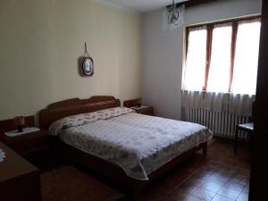 a bedroom with a bed and two windows at Ca' d' Guido in Lisio
