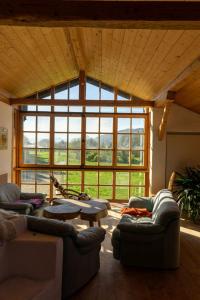 a living room with two couches and a large window at Ferienwohnung mit großem Panoramafenster in Teisendorf +16 photos