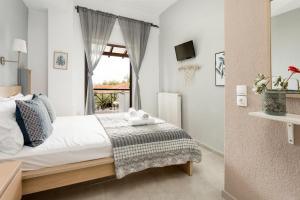 a bedroom with a bed and a window at A. & C. Michailidi (Haris Mihailidis) in Neos Marmaras
