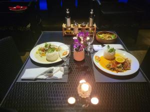 two plates of food on a table with lights at Parrot Resort Moalboal in Moalboal