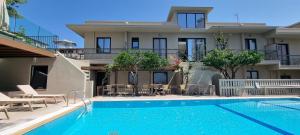 a house with a swimming pool in front of a house at Mariette Rhodes Urban Suites in Rhodes Town