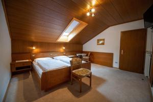 a large bedroom with a bed and a skylight at Apartments Zilli in Laion