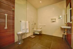a bathroom with a toilet and a glass shower at Quaint Boutique Hotel Xewkija in Xewkija