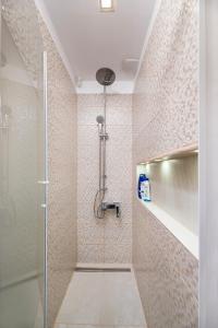 a bathroom with a shower with a glass door at Bucharest Penthouse with Sauna and Terrace in Bucharest