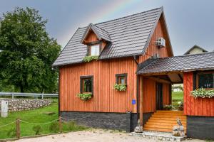 an orange house with a black roof at Etno house Molendini in Rakovica