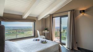 a bedroom with a bed and a large window at Villa Dolphin 10, Emma Villas in Massarosa