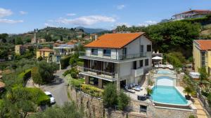 an aerial view of a house with a swimming pool at Villa Dolphin 10, Emma Villas in Massarosa