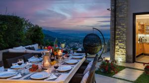 a table set for dinner on a balcony with a view at Villa Dolphin 10, Emma Villas in Massarosa